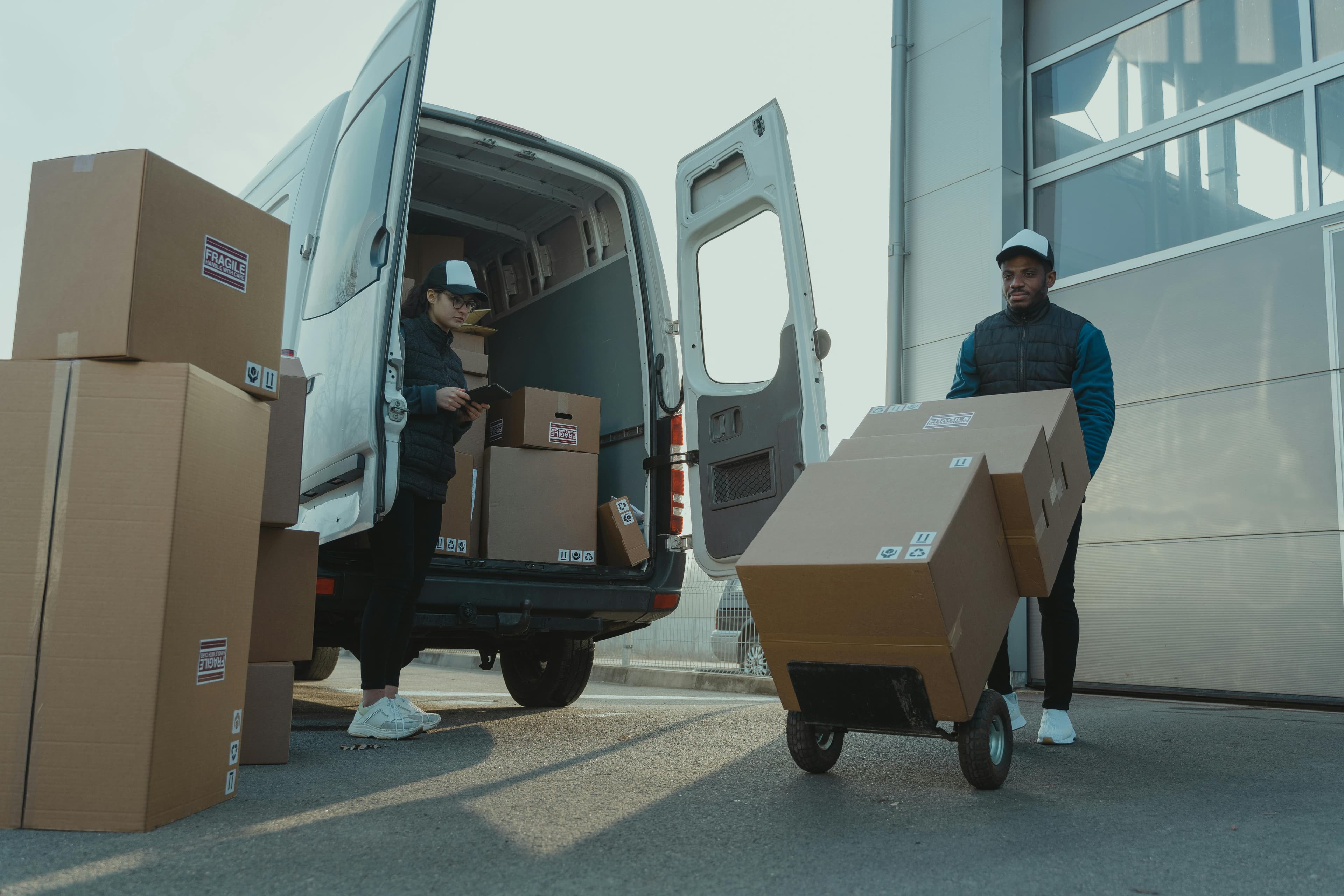 A man unloading parcels from a van.